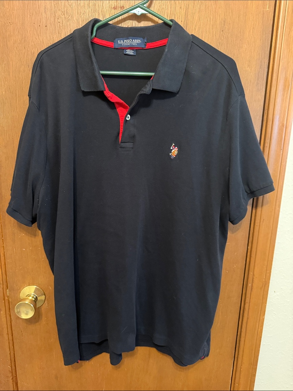 U.S. Polo Assn. Black Polo with Red Placket Detail